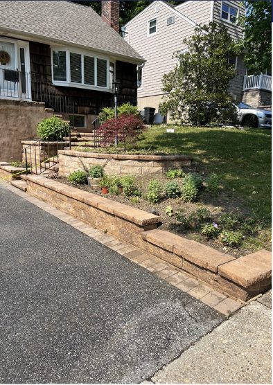 Stone retaining wall before cleaning